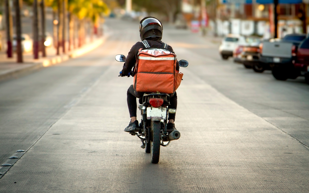 when traveling near a motorcycle, what precautions should be taken by a driver?